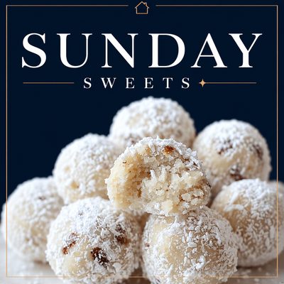 Russian tea balls coated in powdered sugar on a serving platter, also known as snowball cookies.